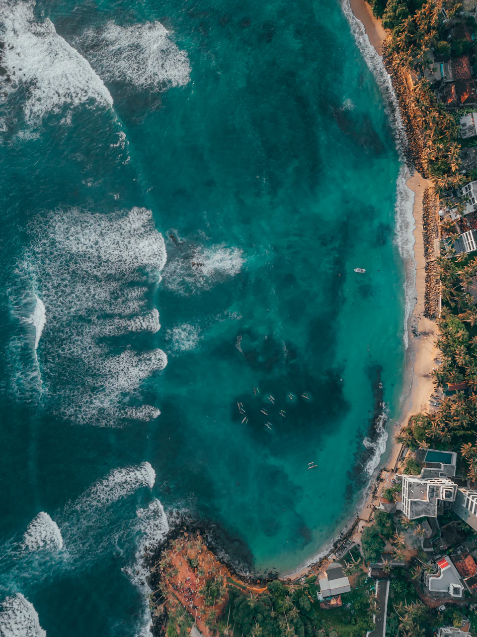 Aerial view of ocean waves along a Sri Lankan beach