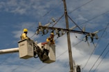 A couple of men working on a power line