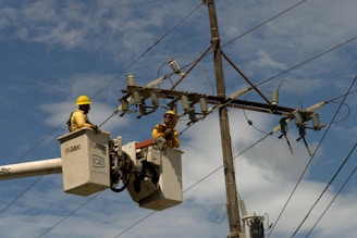 A couple of men working on a power line