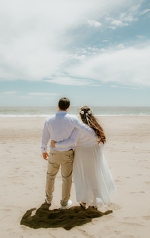 A man and a woman standing on a beach