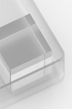 A clear plastic container with three compartments