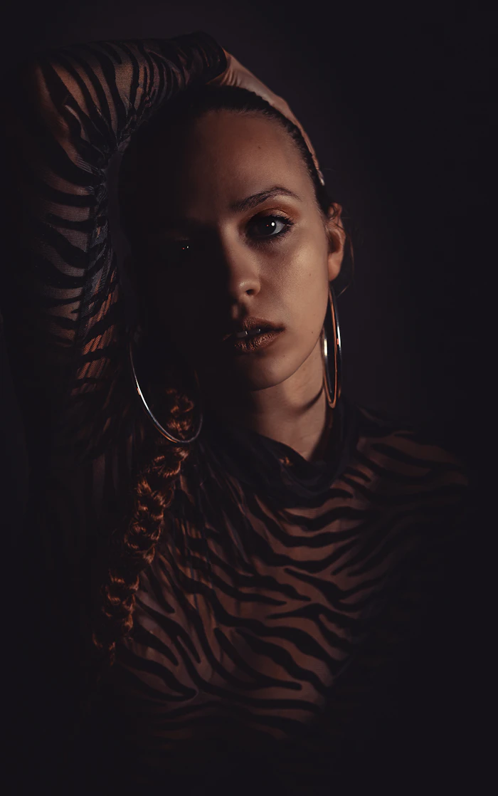 Close portrait, black shirt and hoop earrings, candid editorial