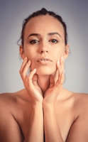 A woman posing with her hands on her face