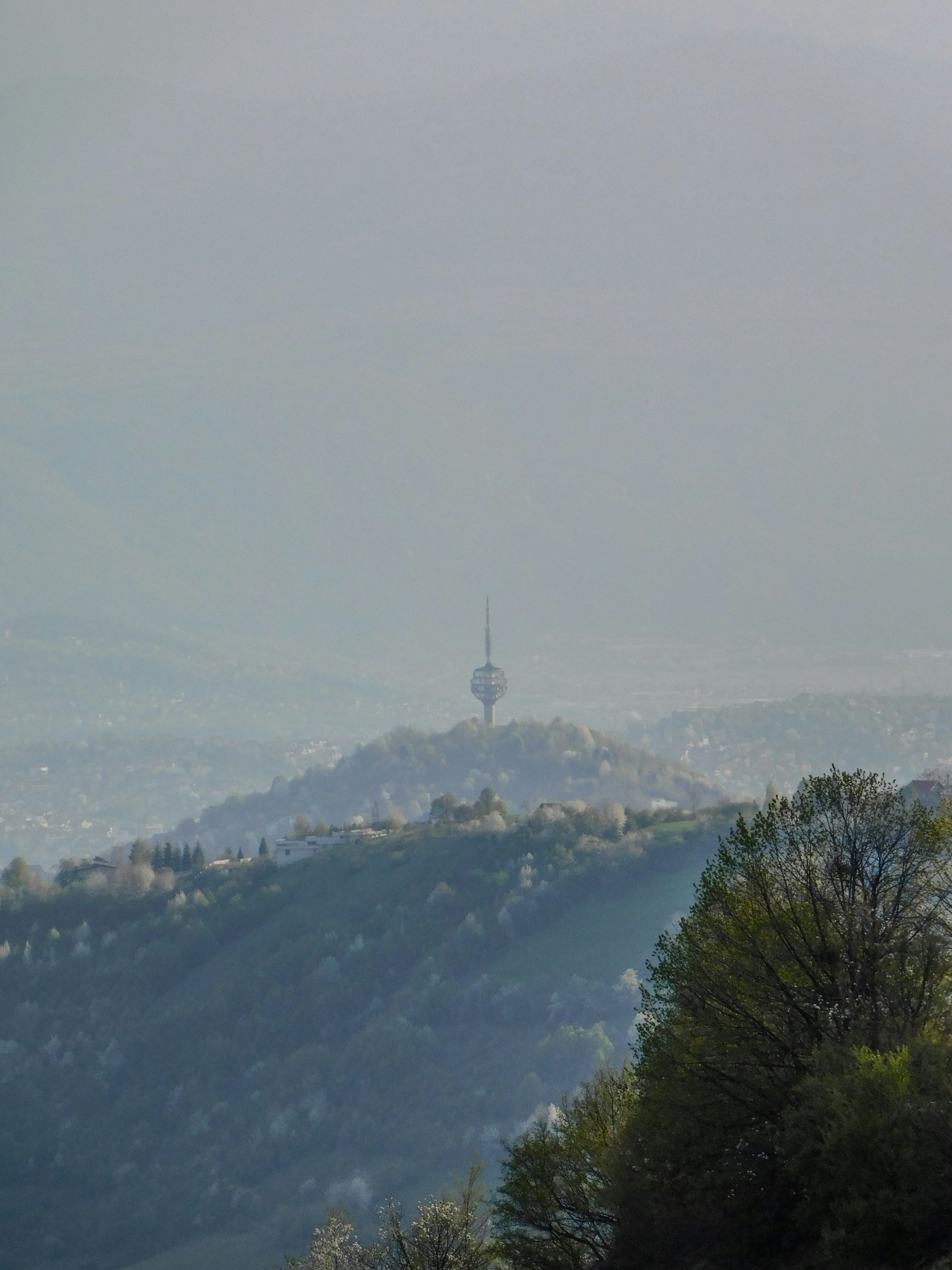 A view of a hill with a tower in the distance