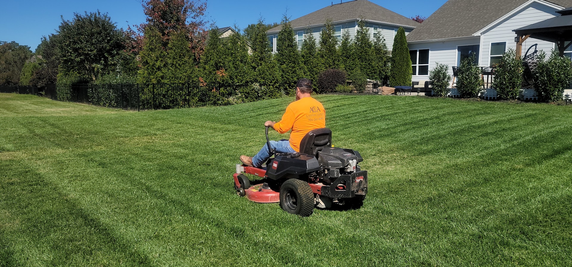 A man riding on the back of a lawn mower
