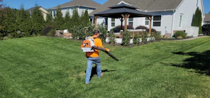 A man in an orange shirt holding a baseball bat