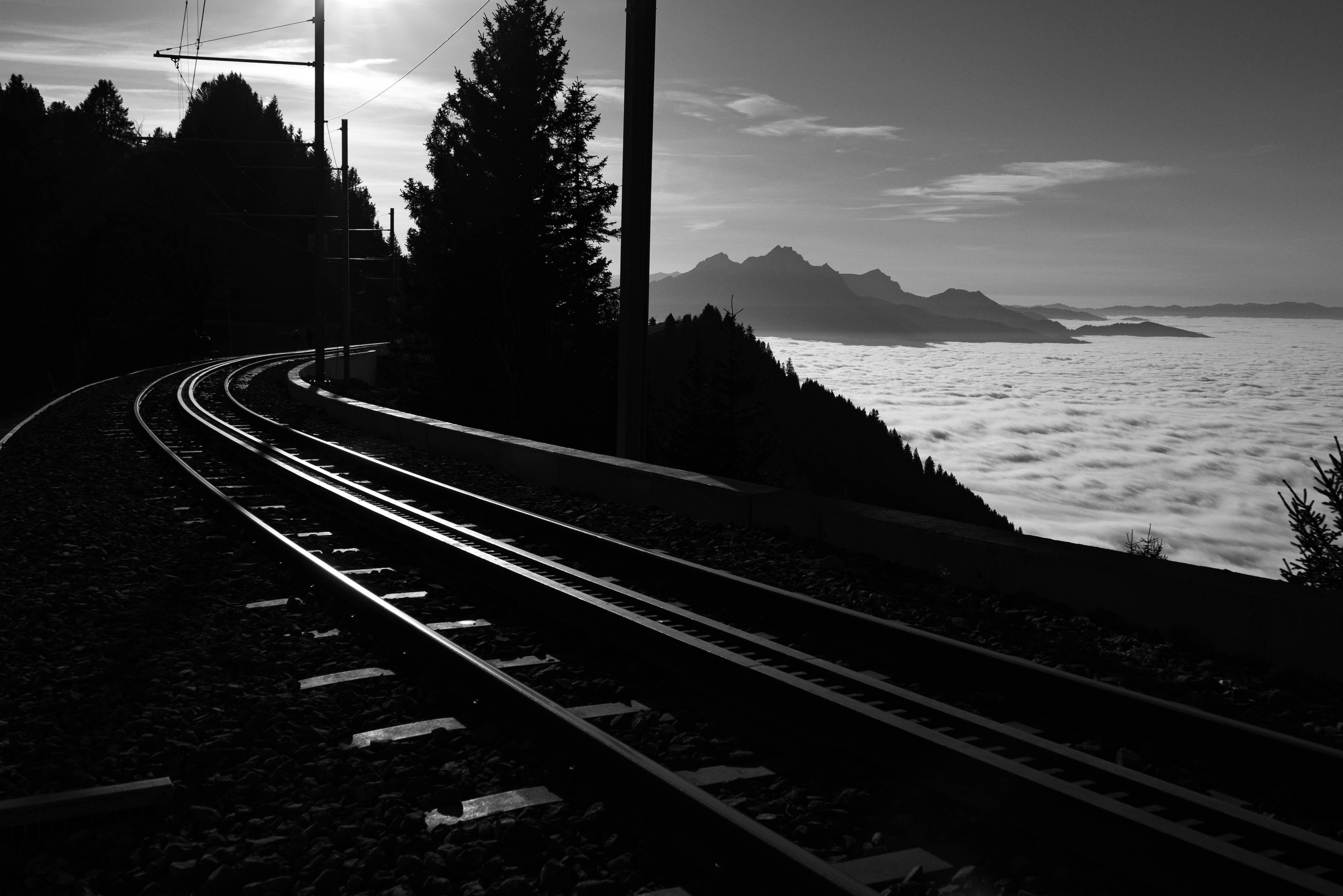 A black and white photo of a train track