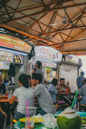 A group of people sitting at a table in a restaurant