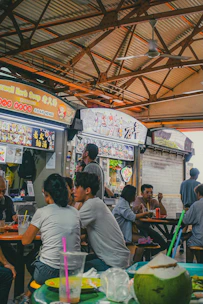 A group of people sitting at a table in a restaurant