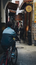 A man riding a bike down a street