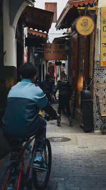 A man riding a bike down a street
