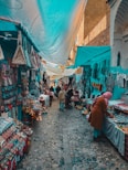 A woman is walking through an outdoor market