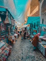 A woman is walking through an outdoor market