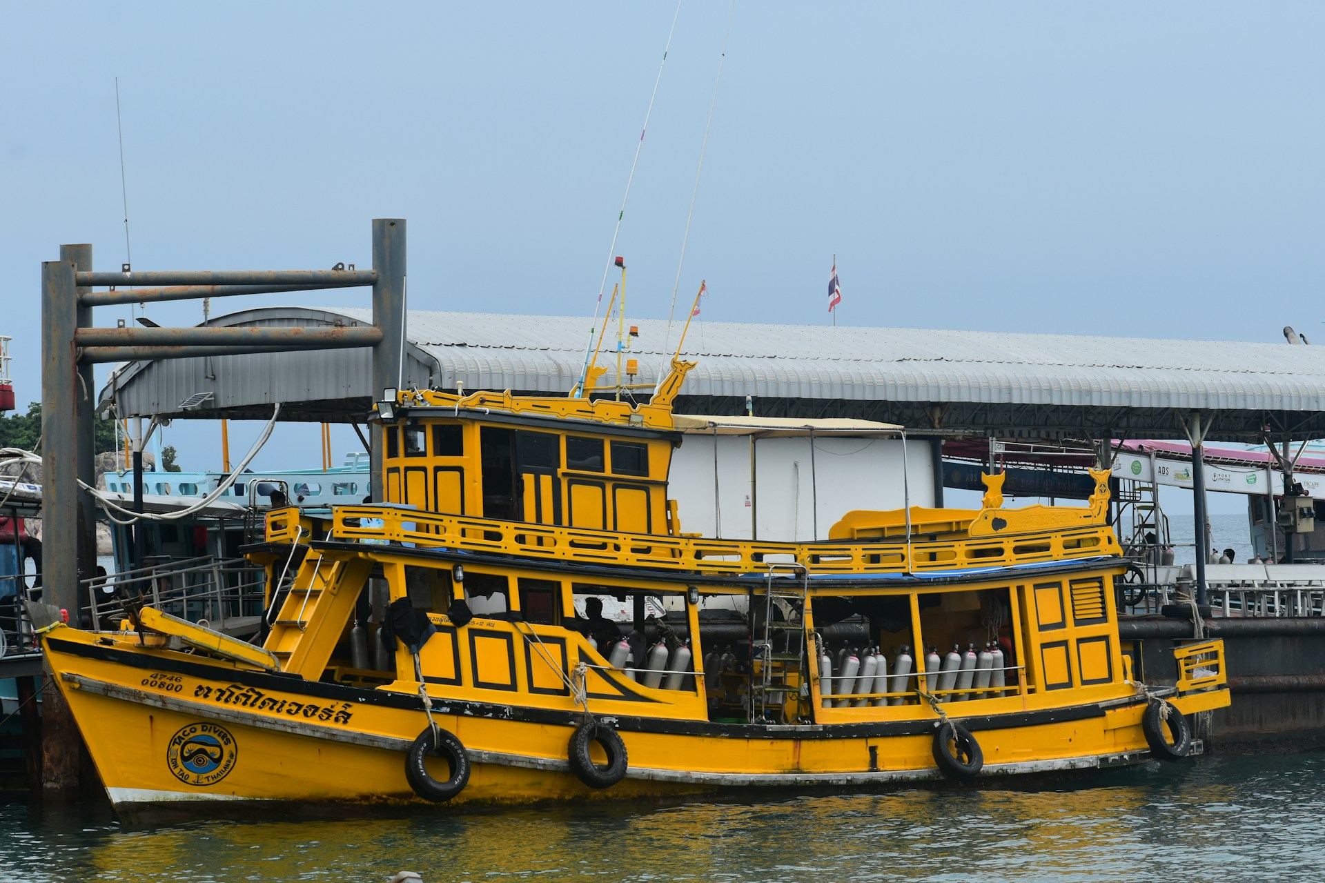 A large yellow boat floating on top of a body of water