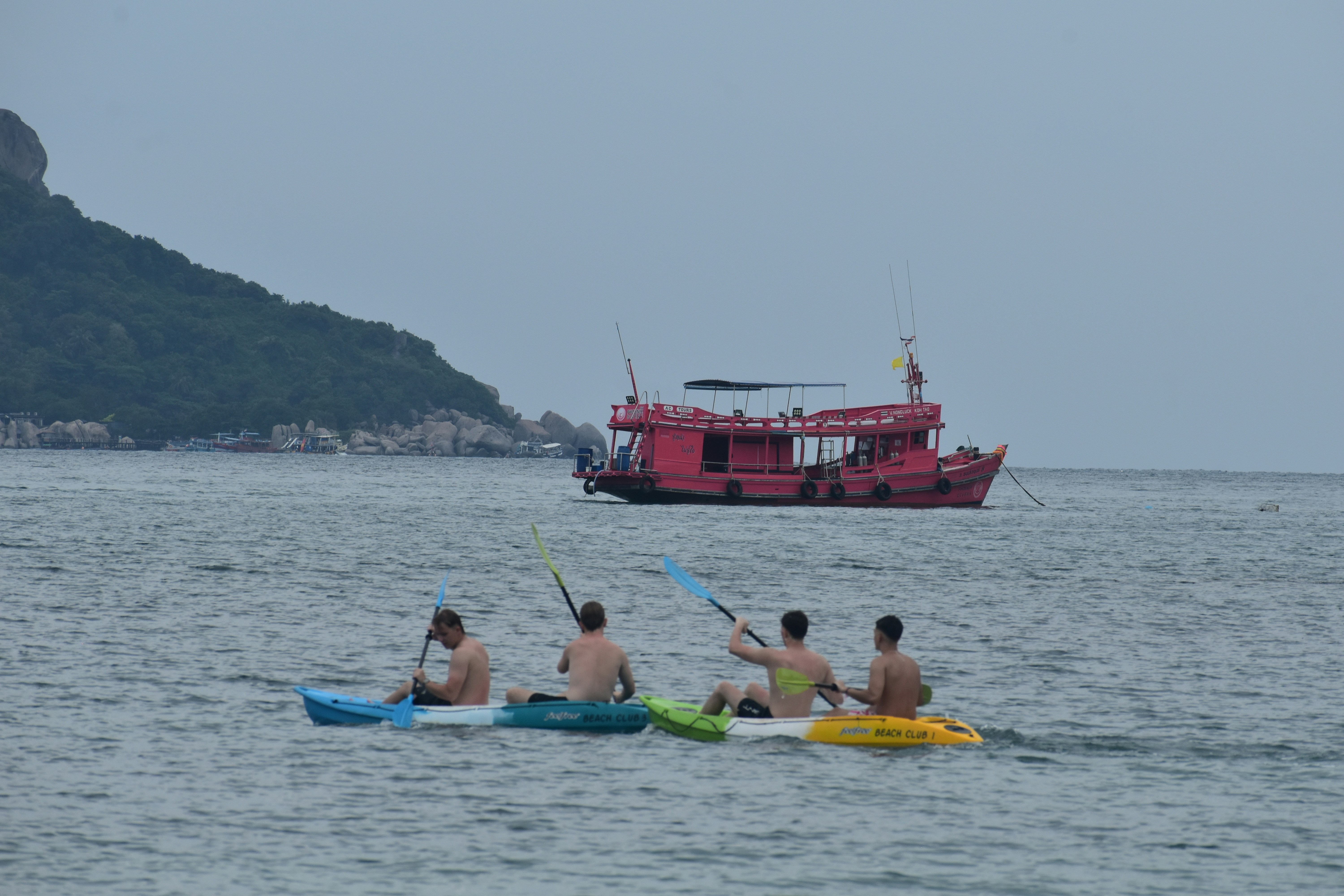 A group of people riding kayaks on top of a body of water