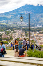 A group of people sitting on top of a cement bench