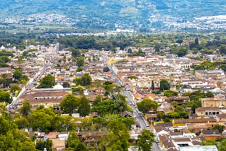 An aerial view of a city with mountains in the background