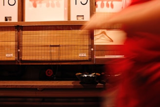 A woman in a red dress is standing in front of a store