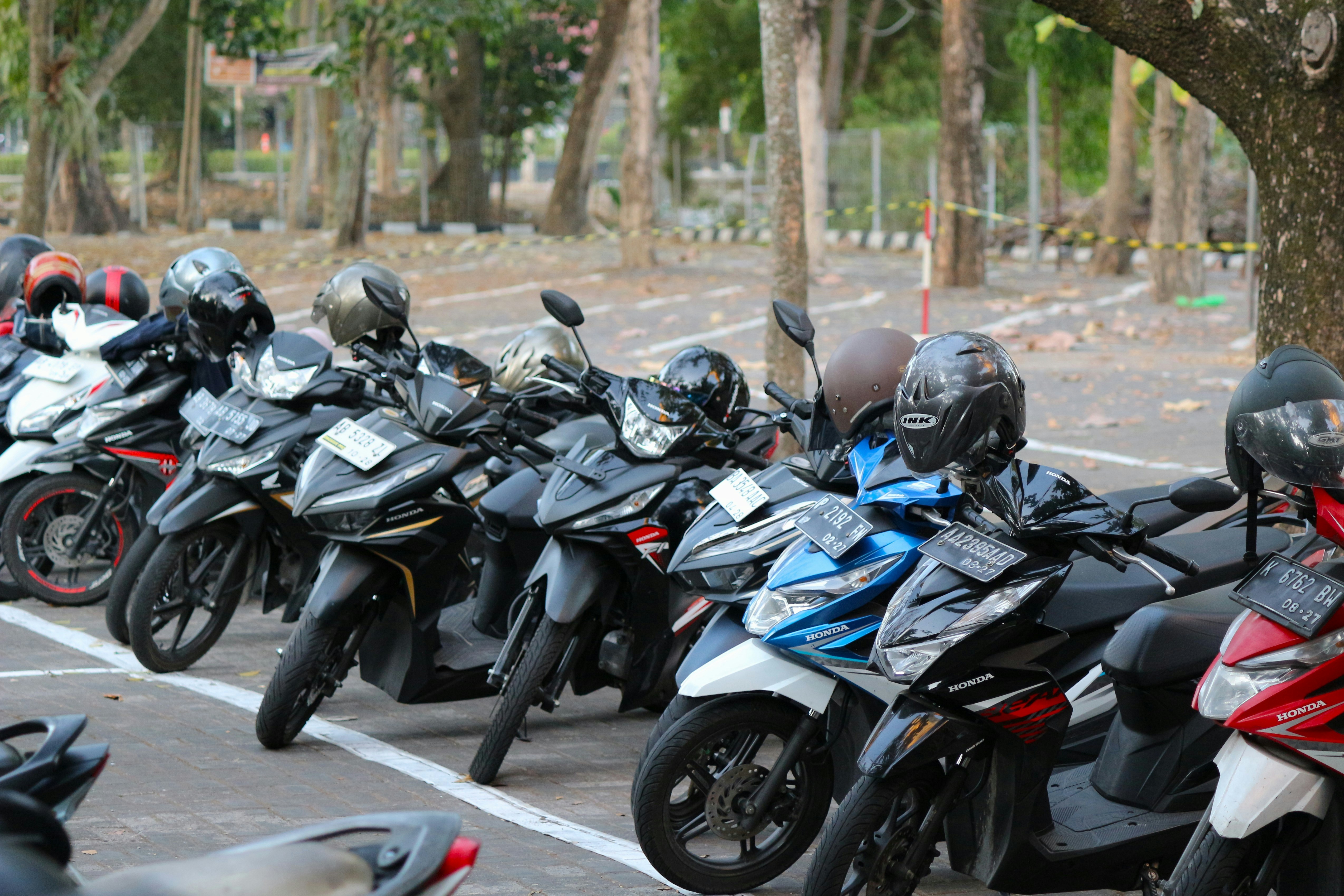 A row of motorcycles parked in a parking lot