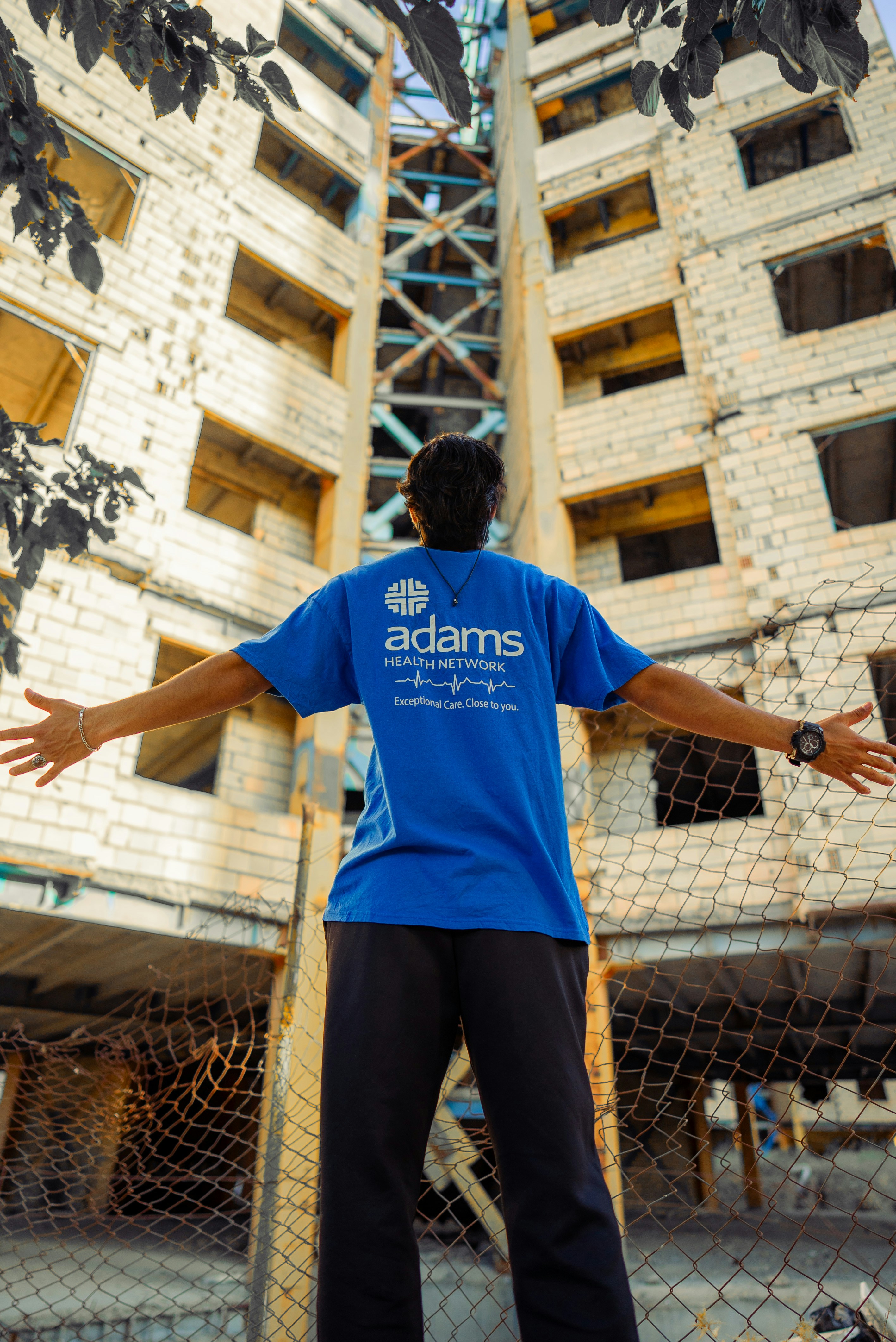 A man standing on a skateboard in front of a building