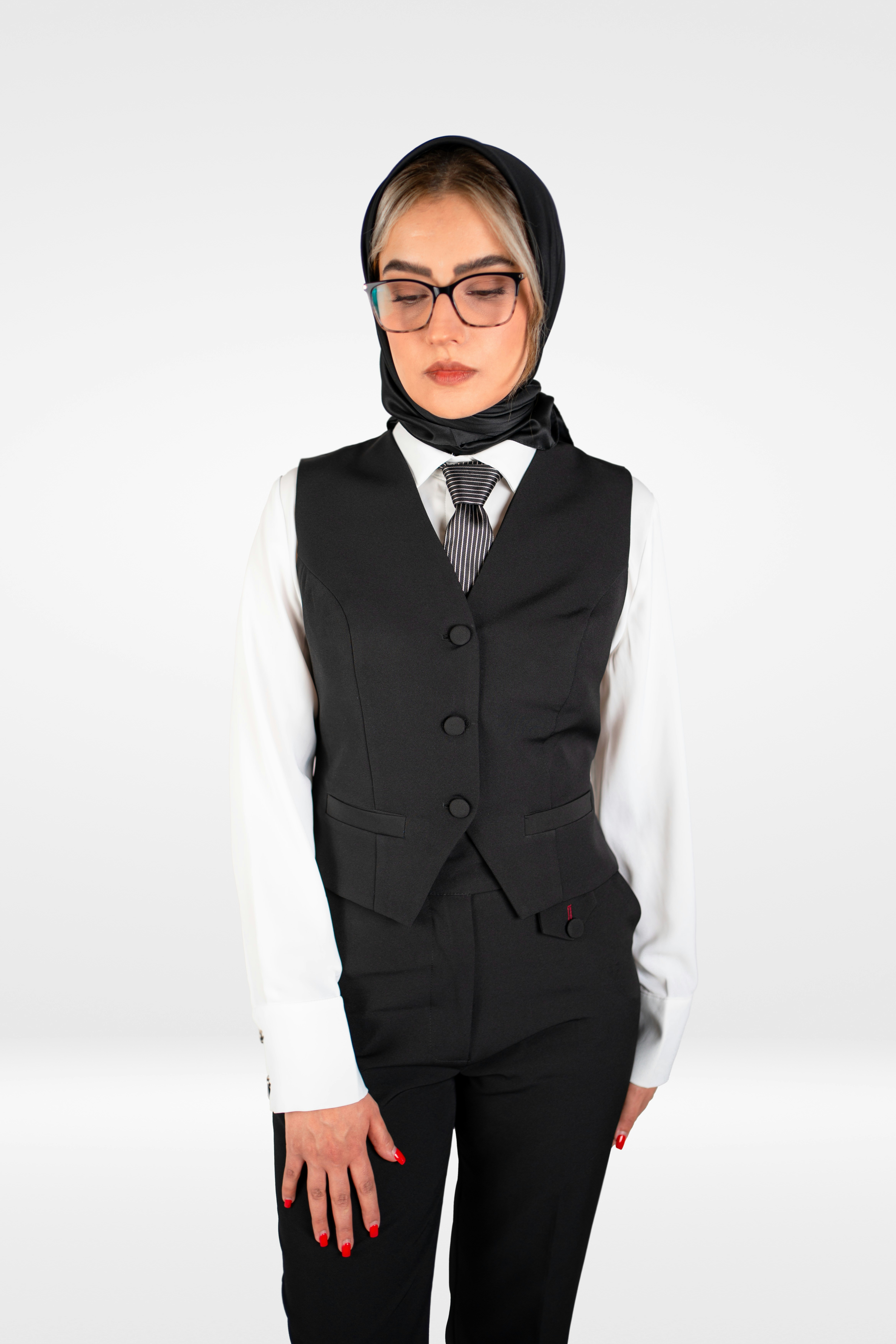 A woman in a suit and tie posing for a picture
