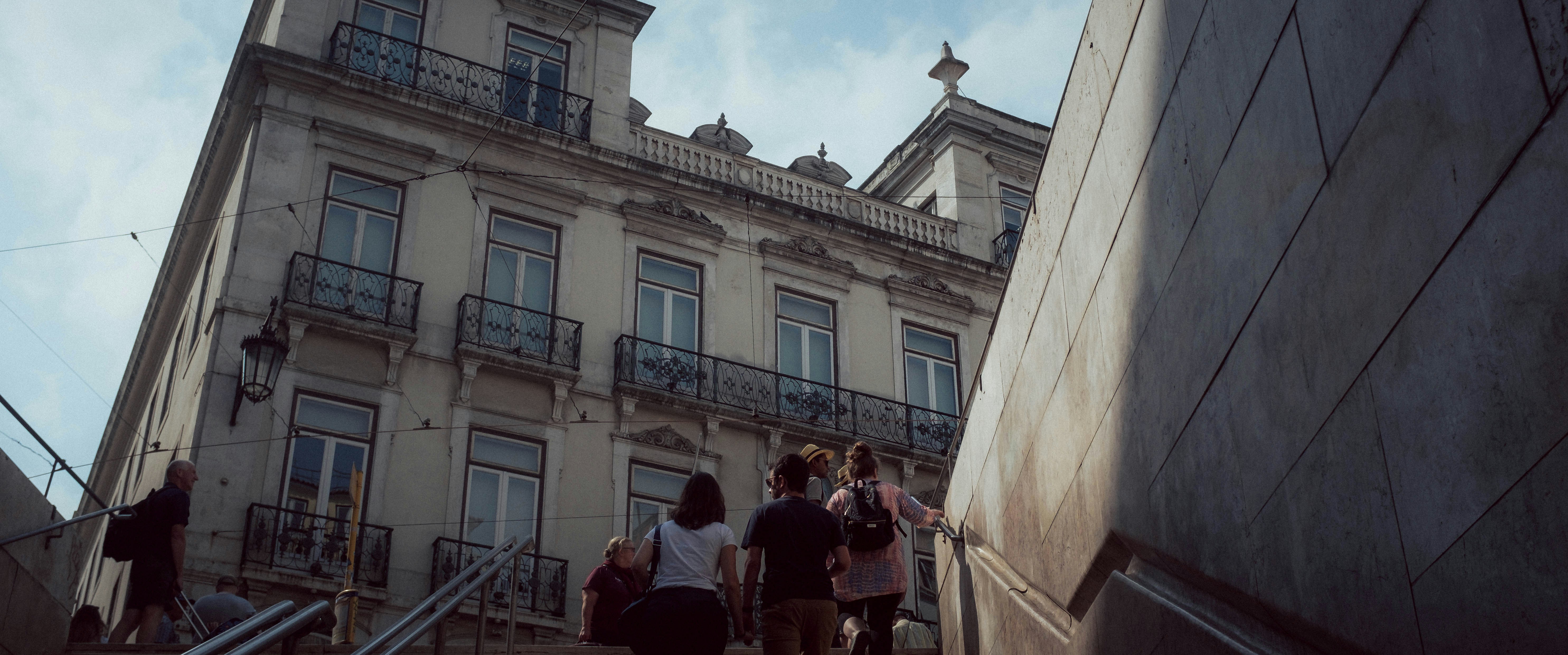 A group of people walking up a flight of stairs photo – Free City Image ...