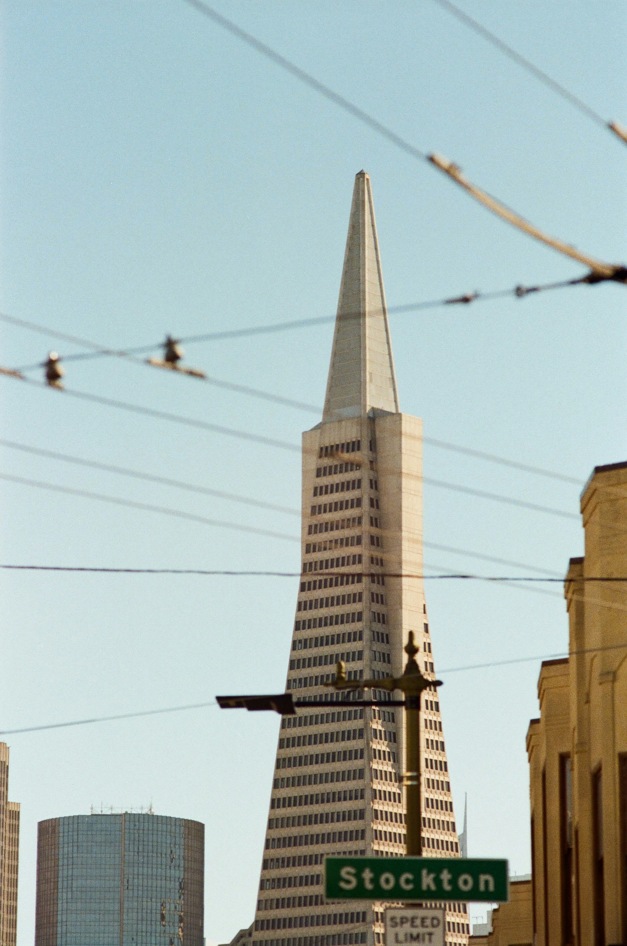 A street sign in front of a very tall building