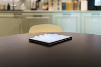 A table with a cell phone on top of it