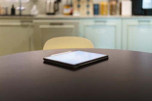 A table with a cell phone on top of it