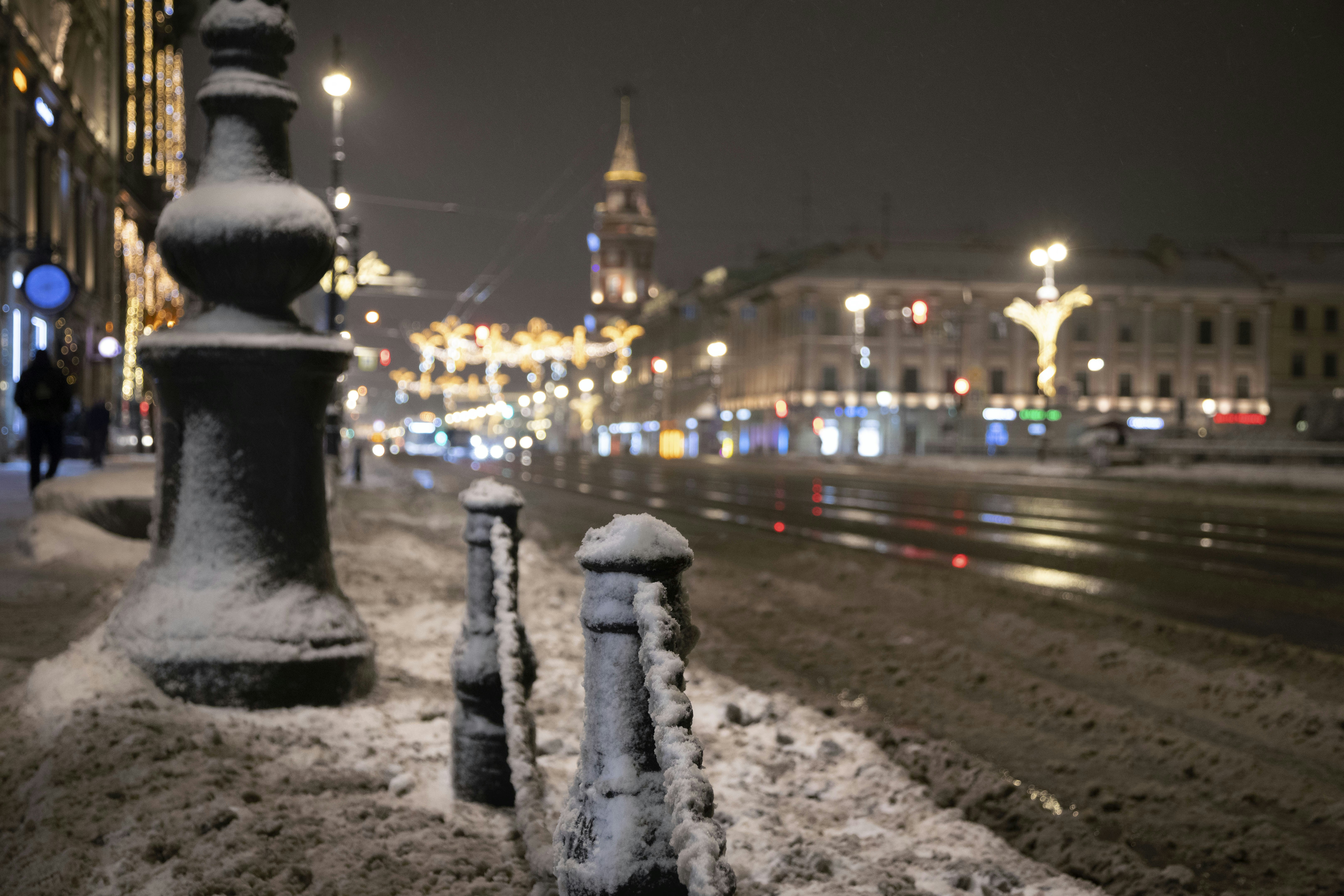 A city street at night covered in snow