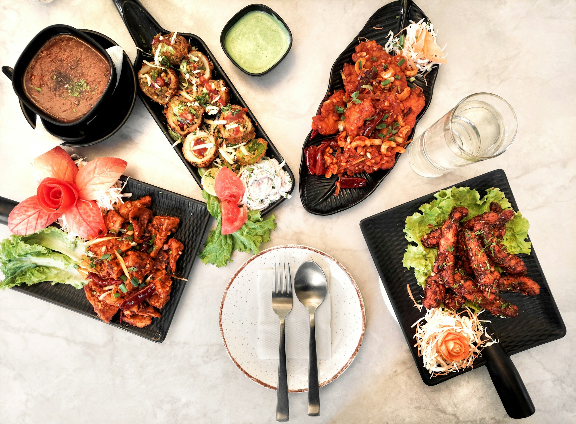 A table topped with plates of food and silverware