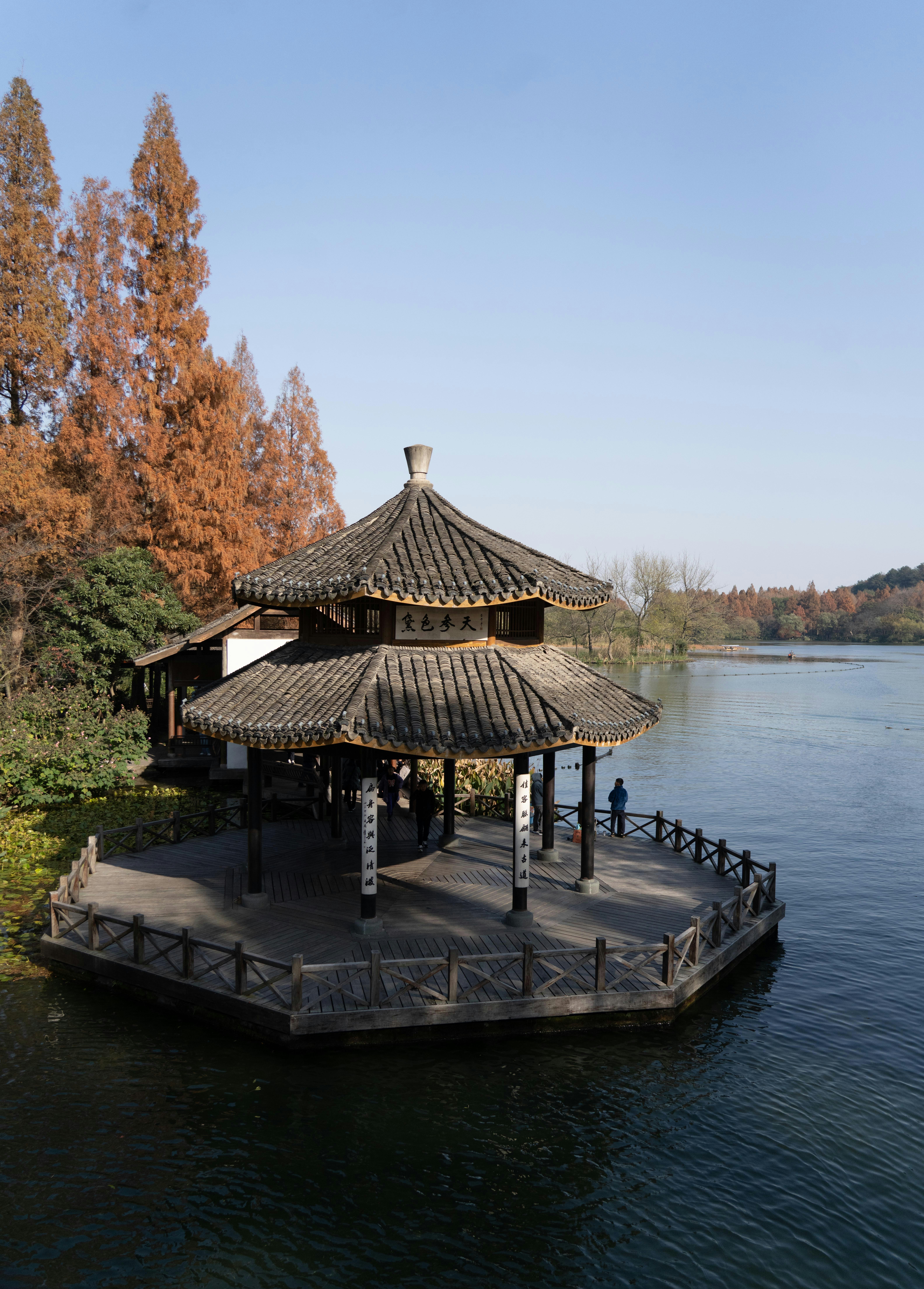 A gazebo sitting on top of a pier next to a body of water