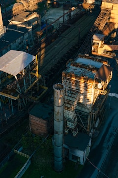An aerial view of an industrial area with a train on the tracks