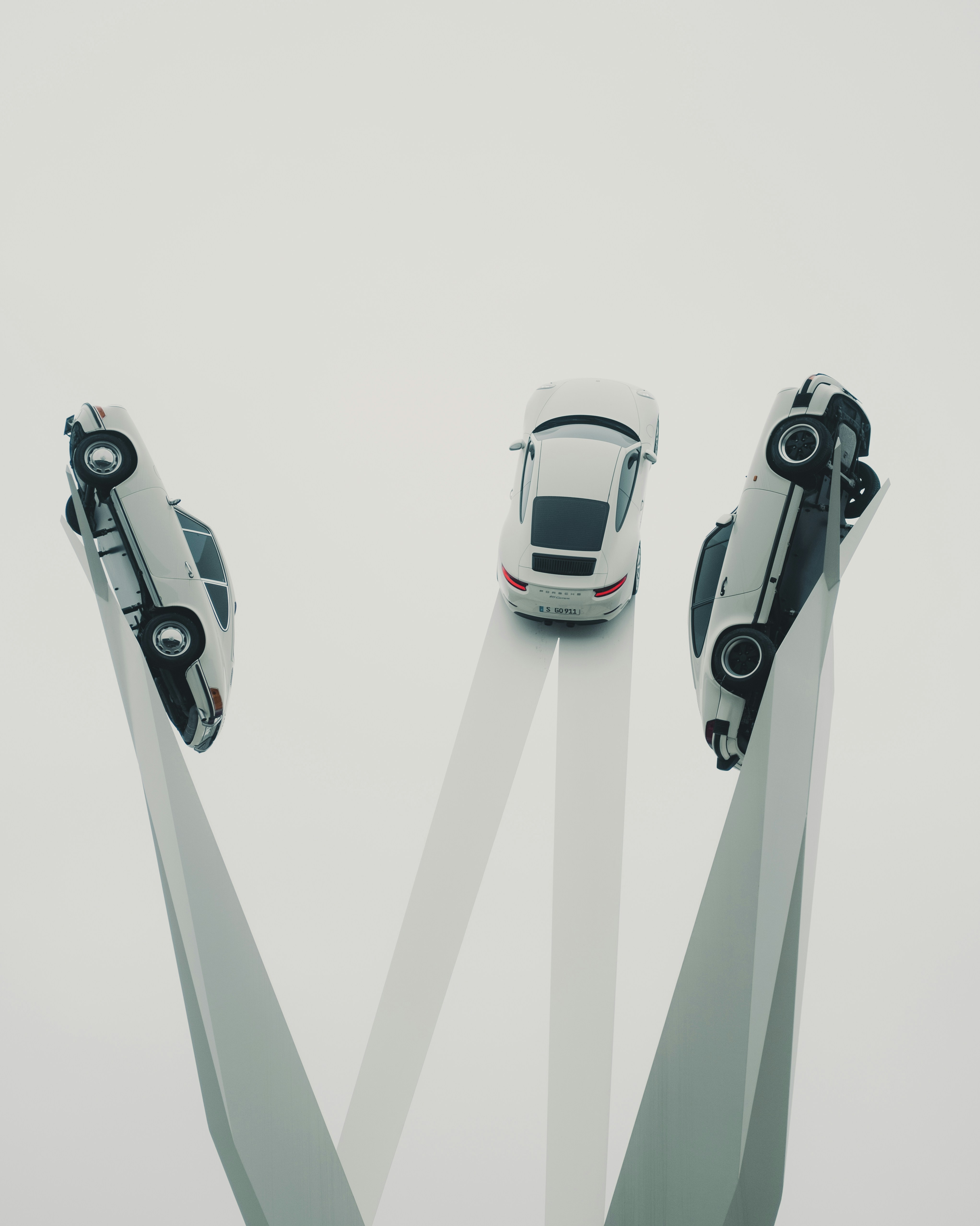 Two cars are in the middle of a pair of skis