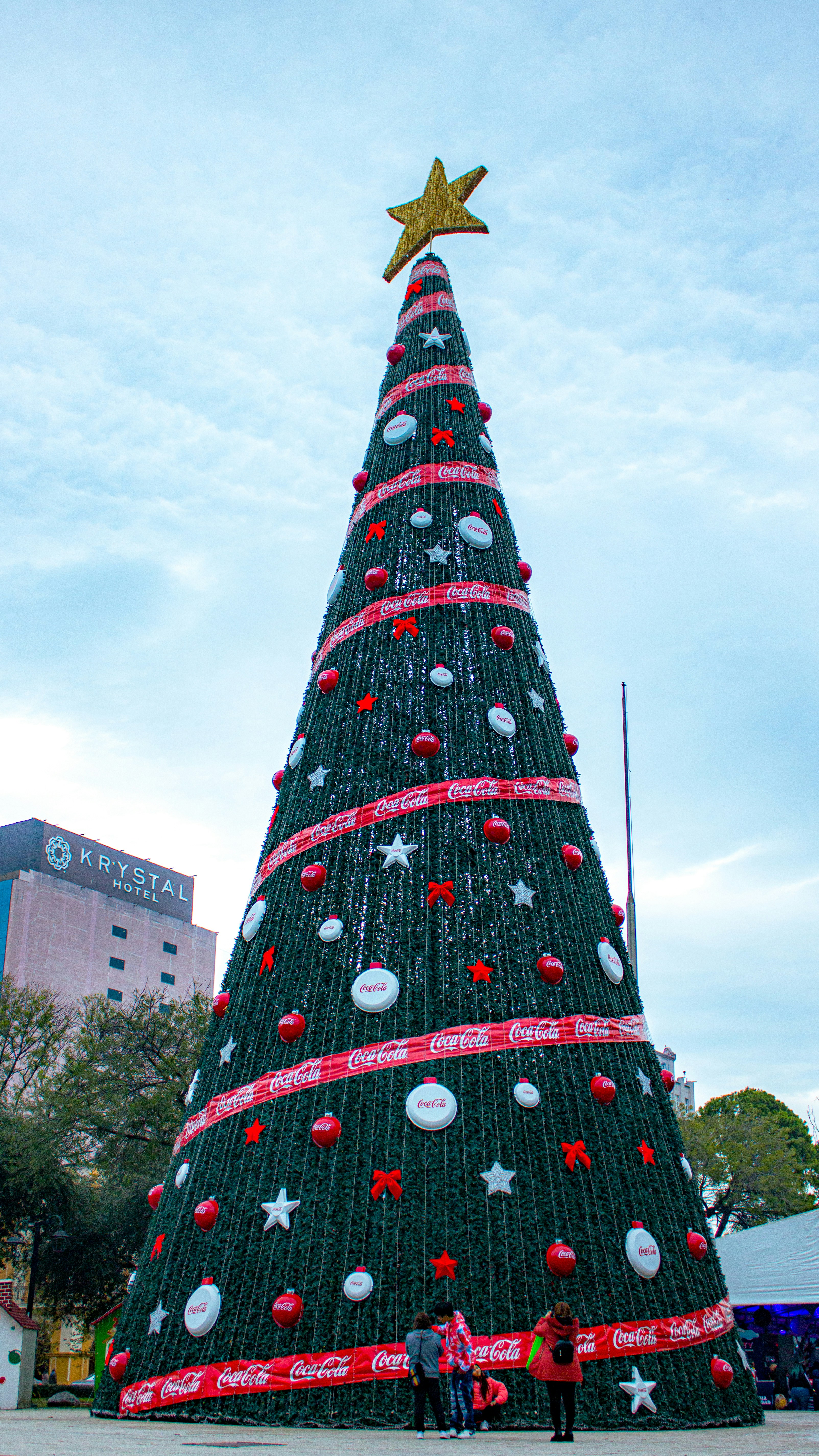 A large christmas tree with a star on top photo – Free Woman Image on ...