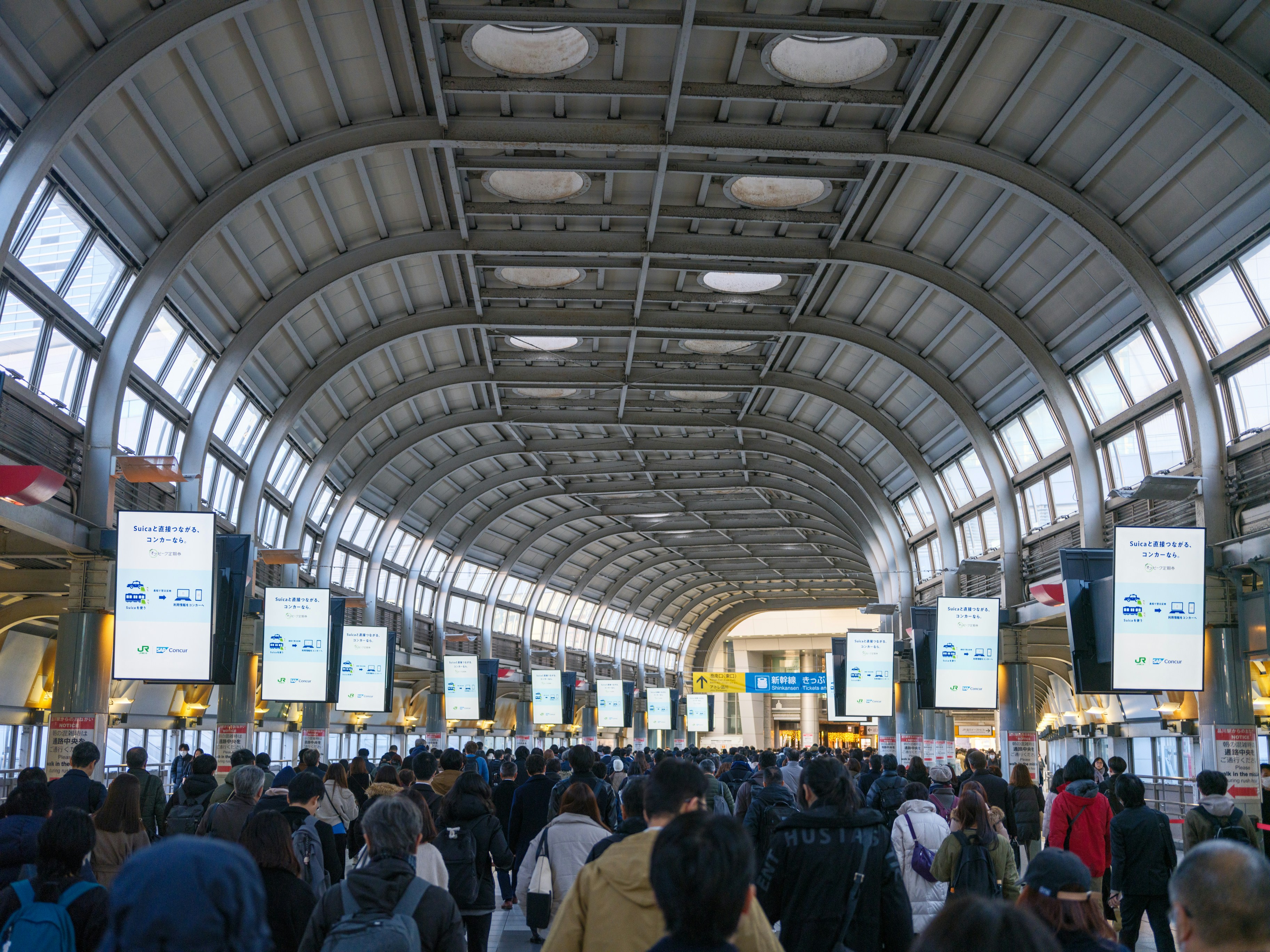 Crowded Japanese train station platform during a service disruption