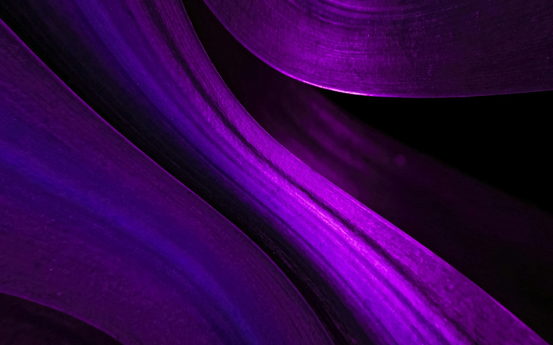 A close up of a purple and black background