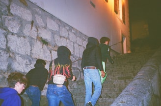 A group of people climbing up a set of stairs