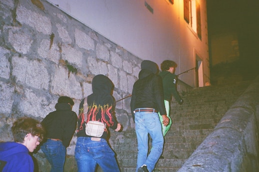 A group of people climbing up a set of stairs
