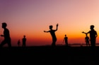 A group of people standing on top of a beach
