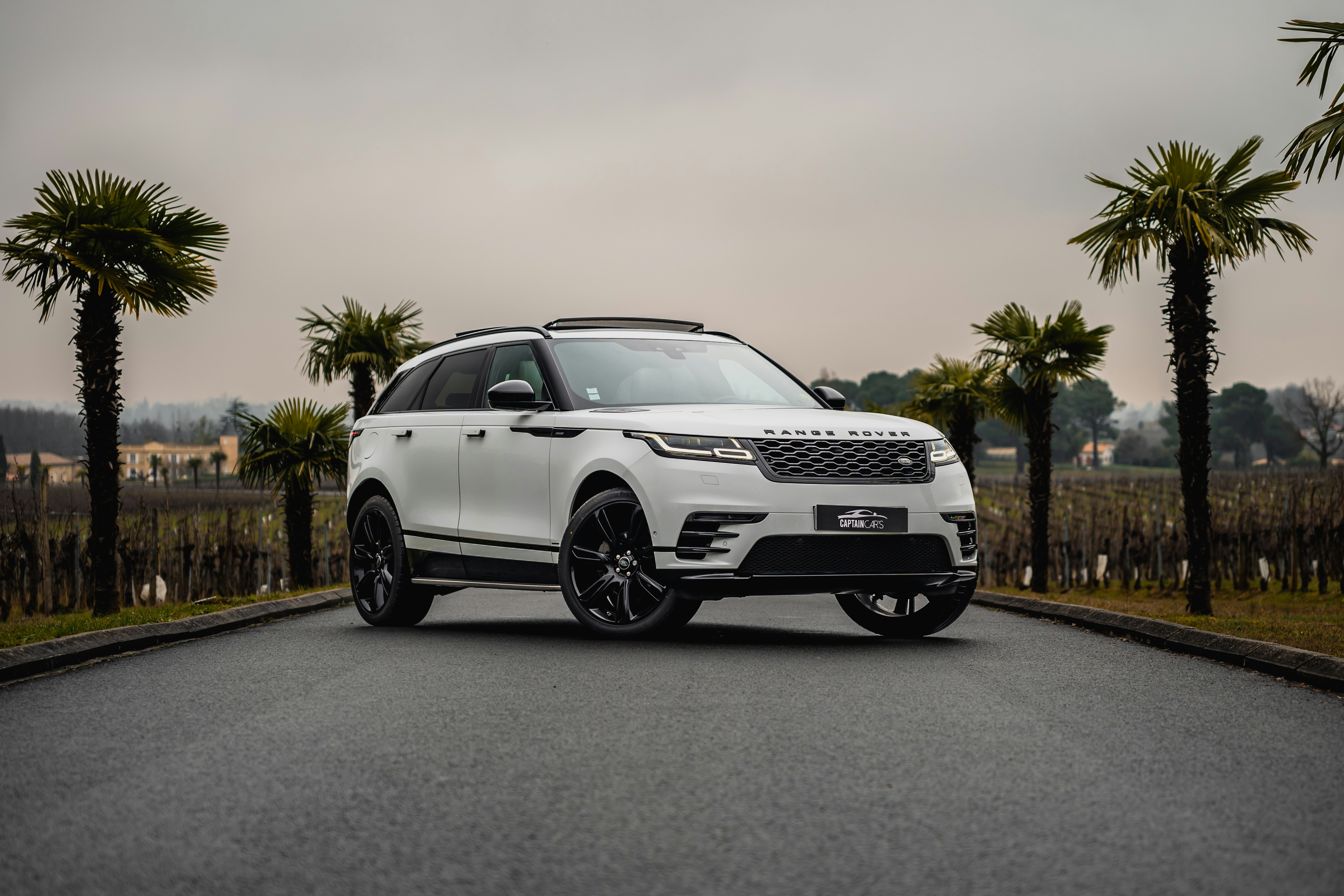 A white range rover parked on the side of a road photo – Free Captain ...