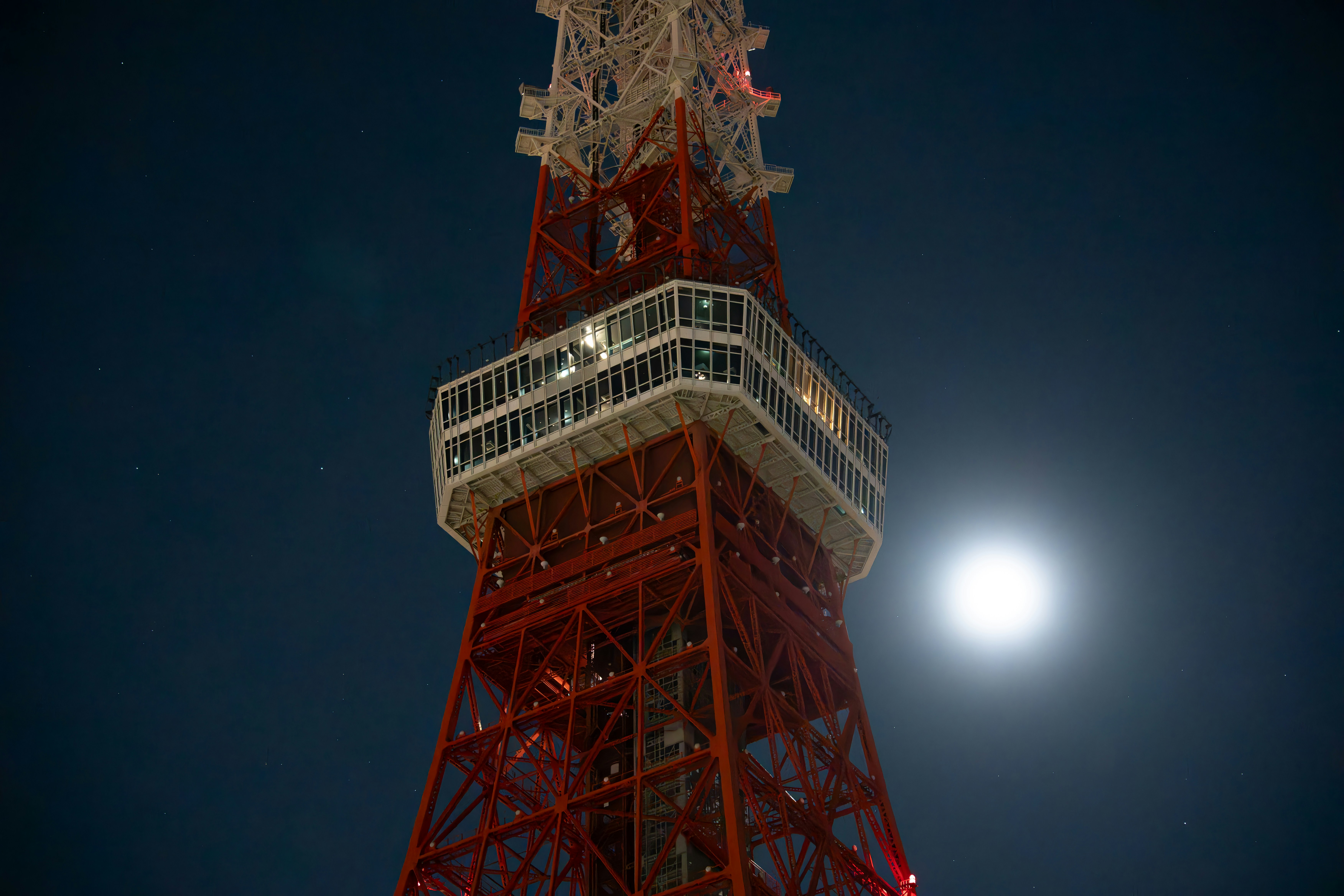 A very tall tower with a clock on it's side