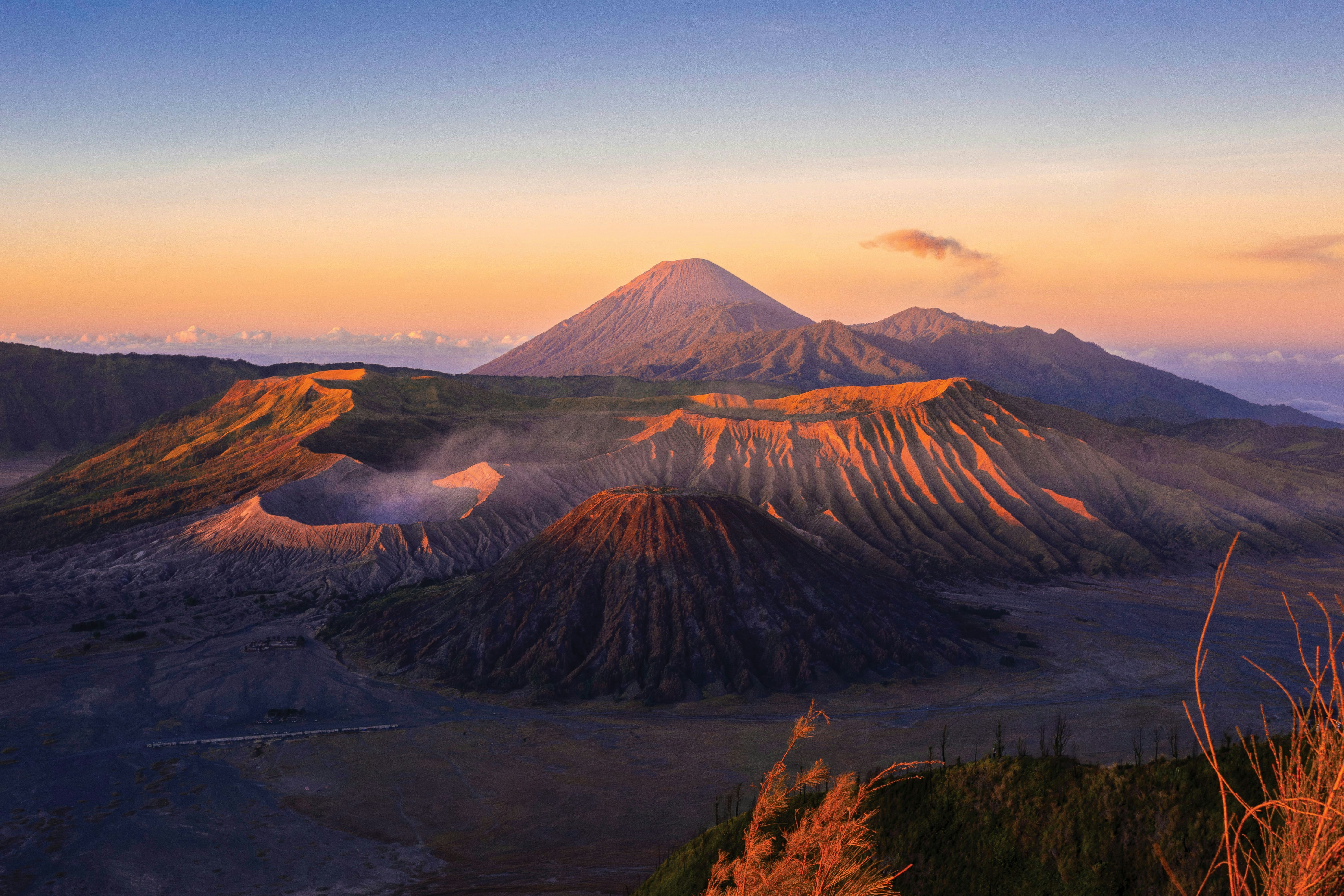 A view of a mountain at sunset with clouds