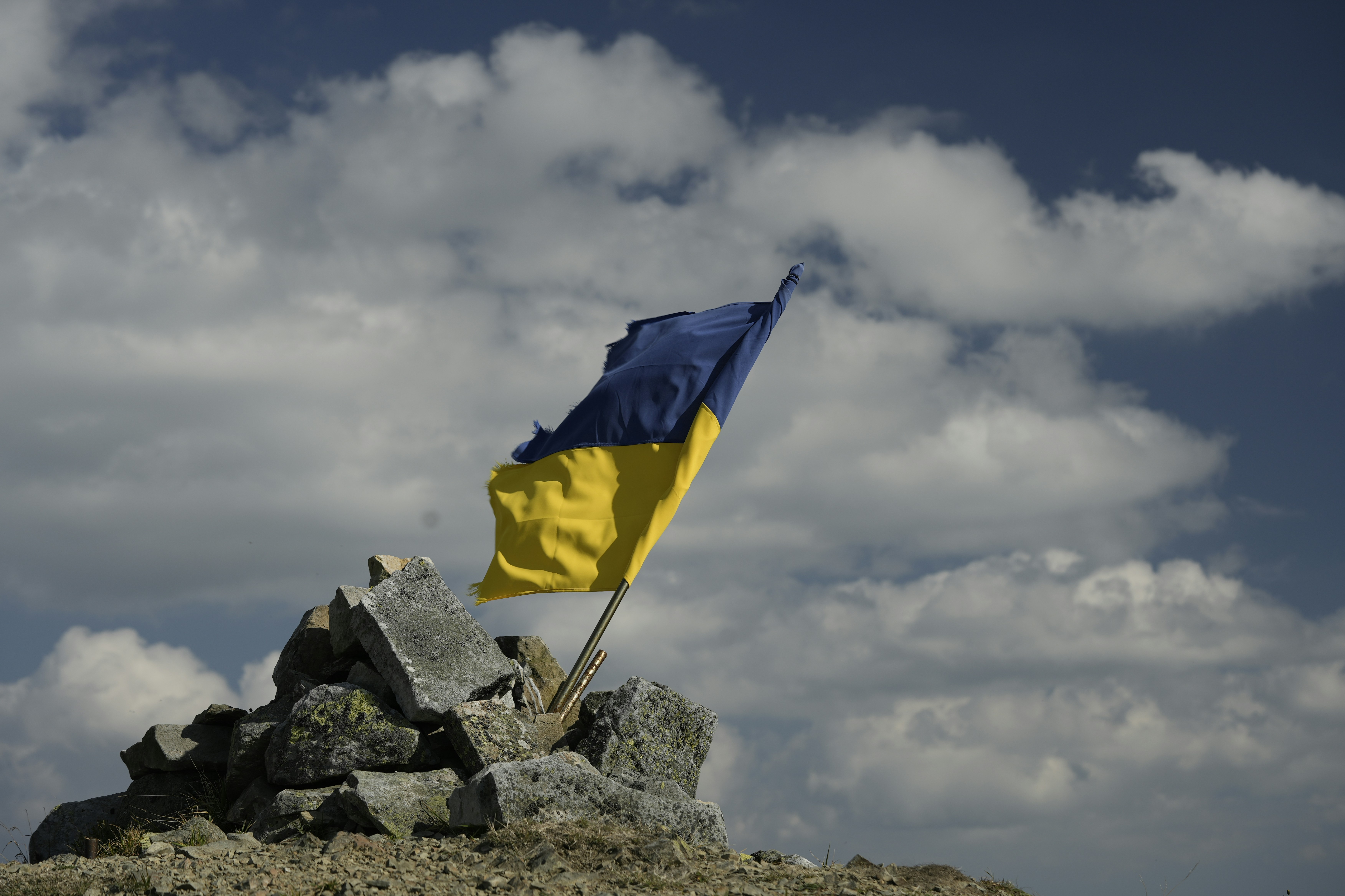 A flag on top of a pile of rocks