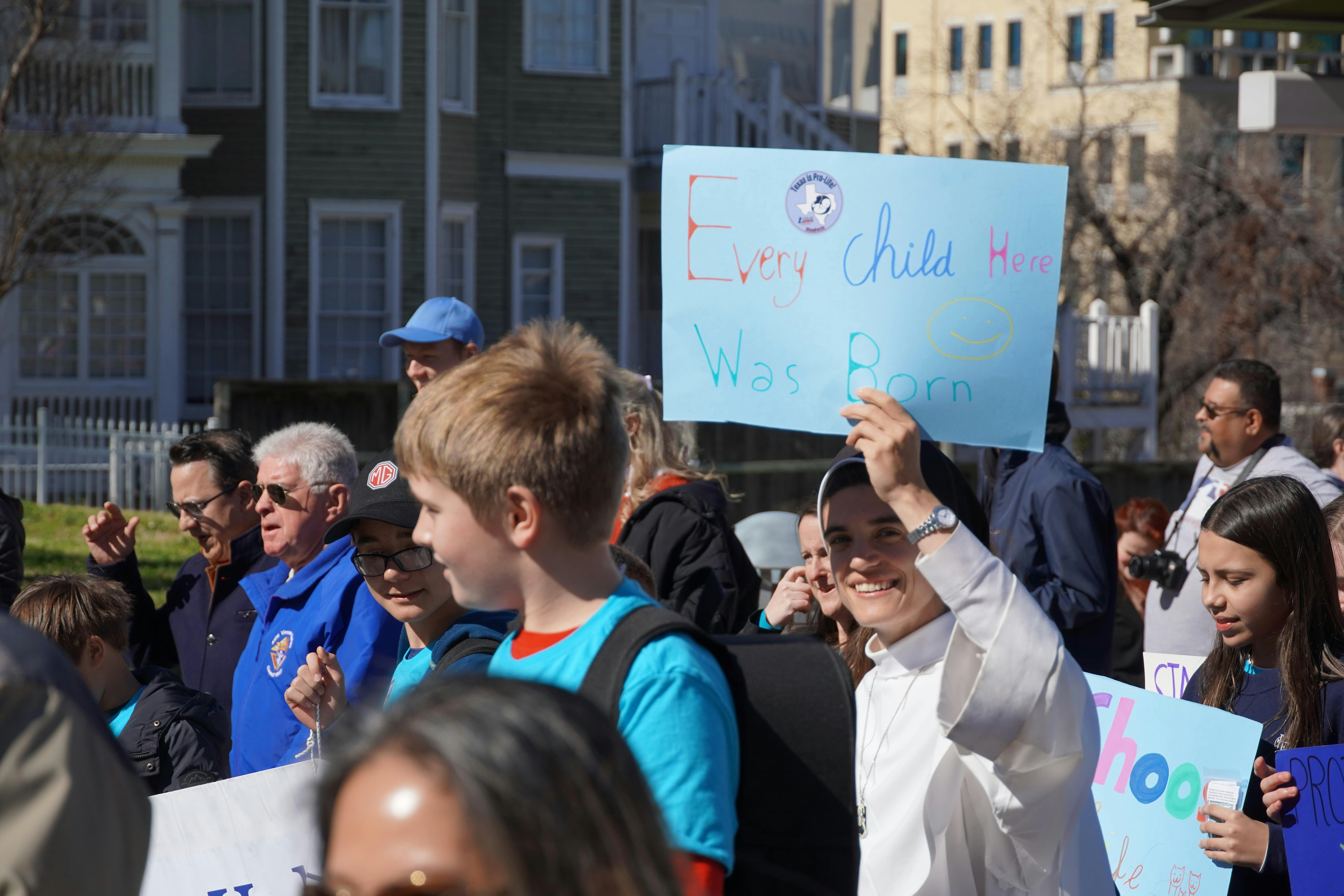 A group of people holding up signs in the street