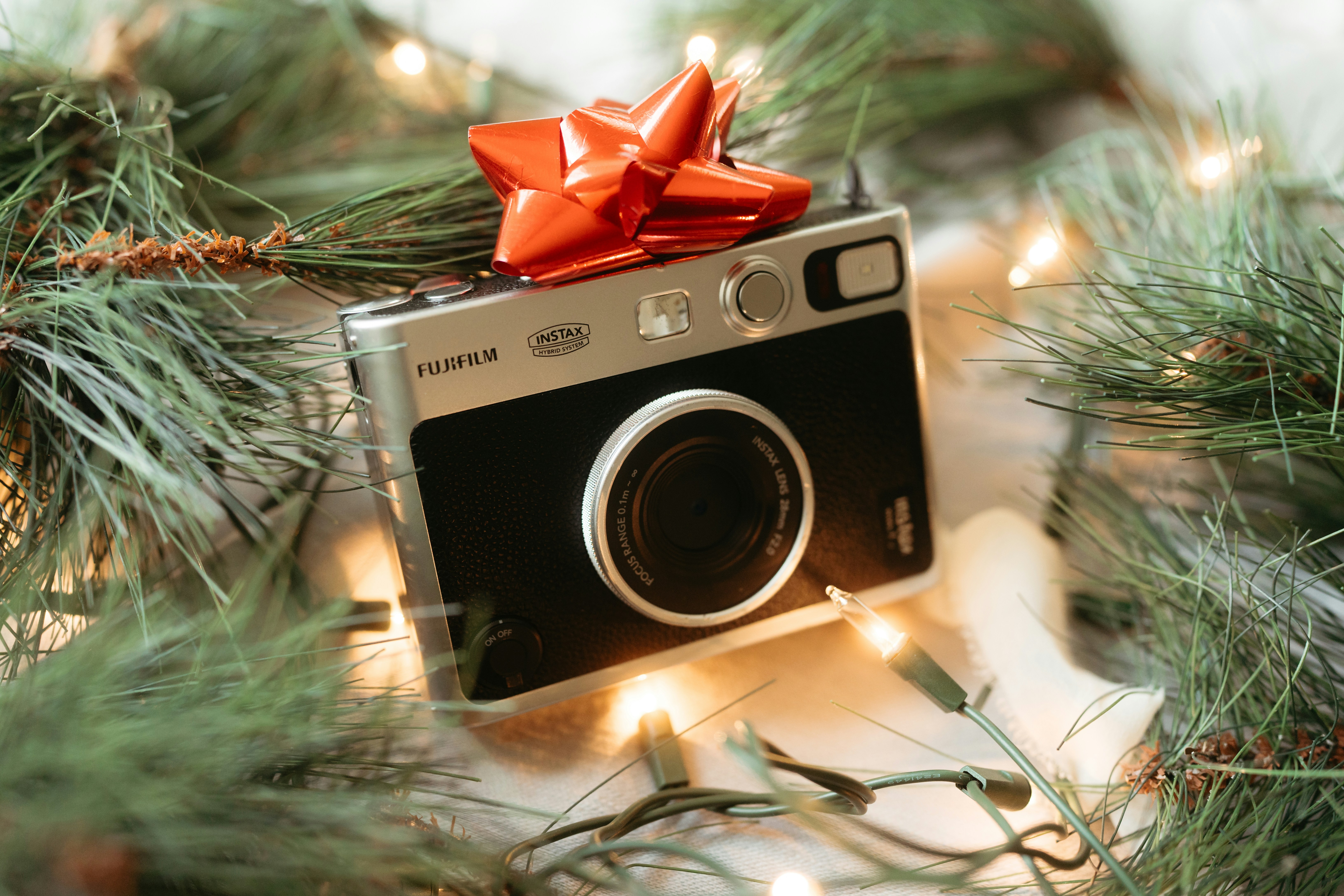 A camera with a red bow on top of it