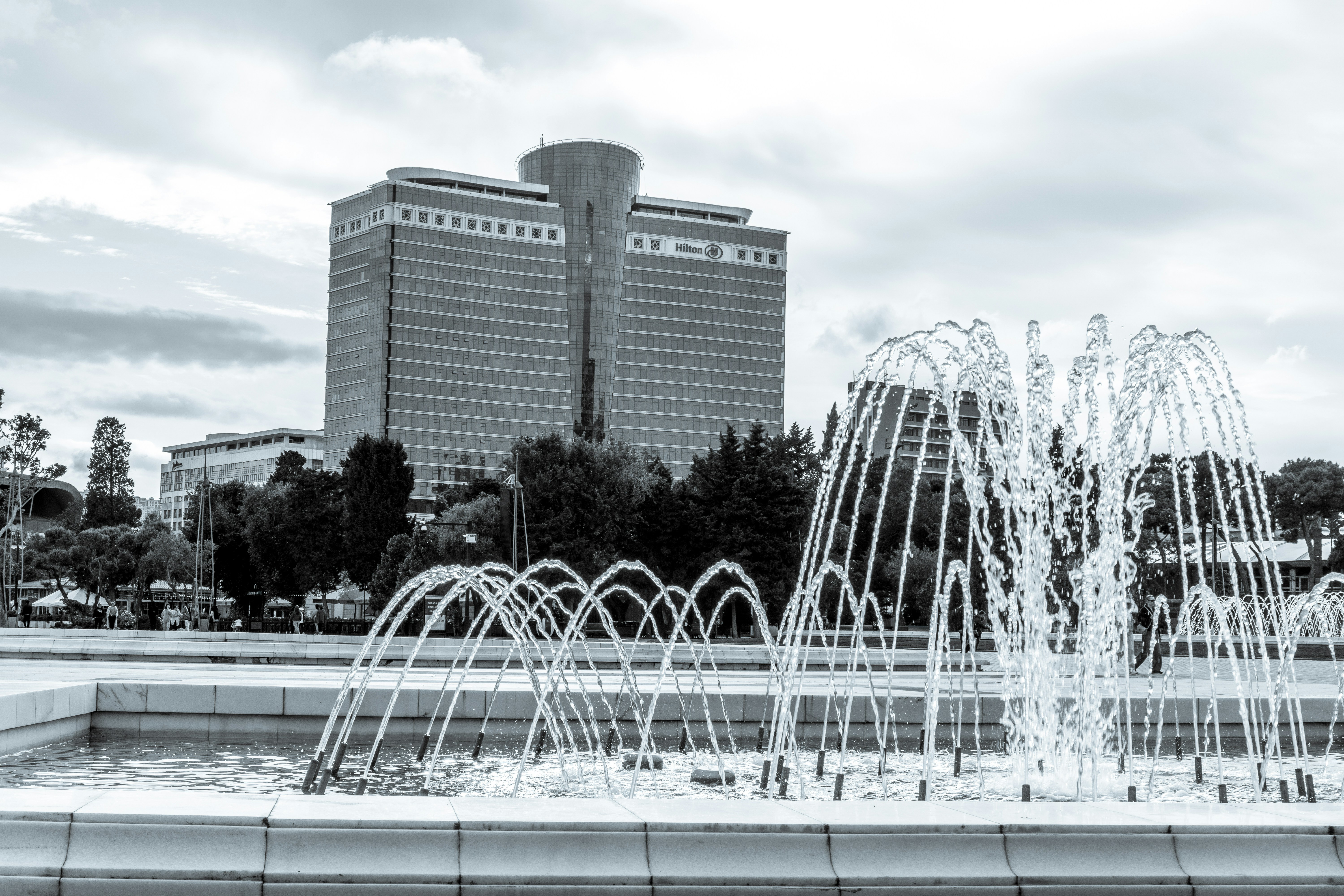 A water fountain in front of a large building