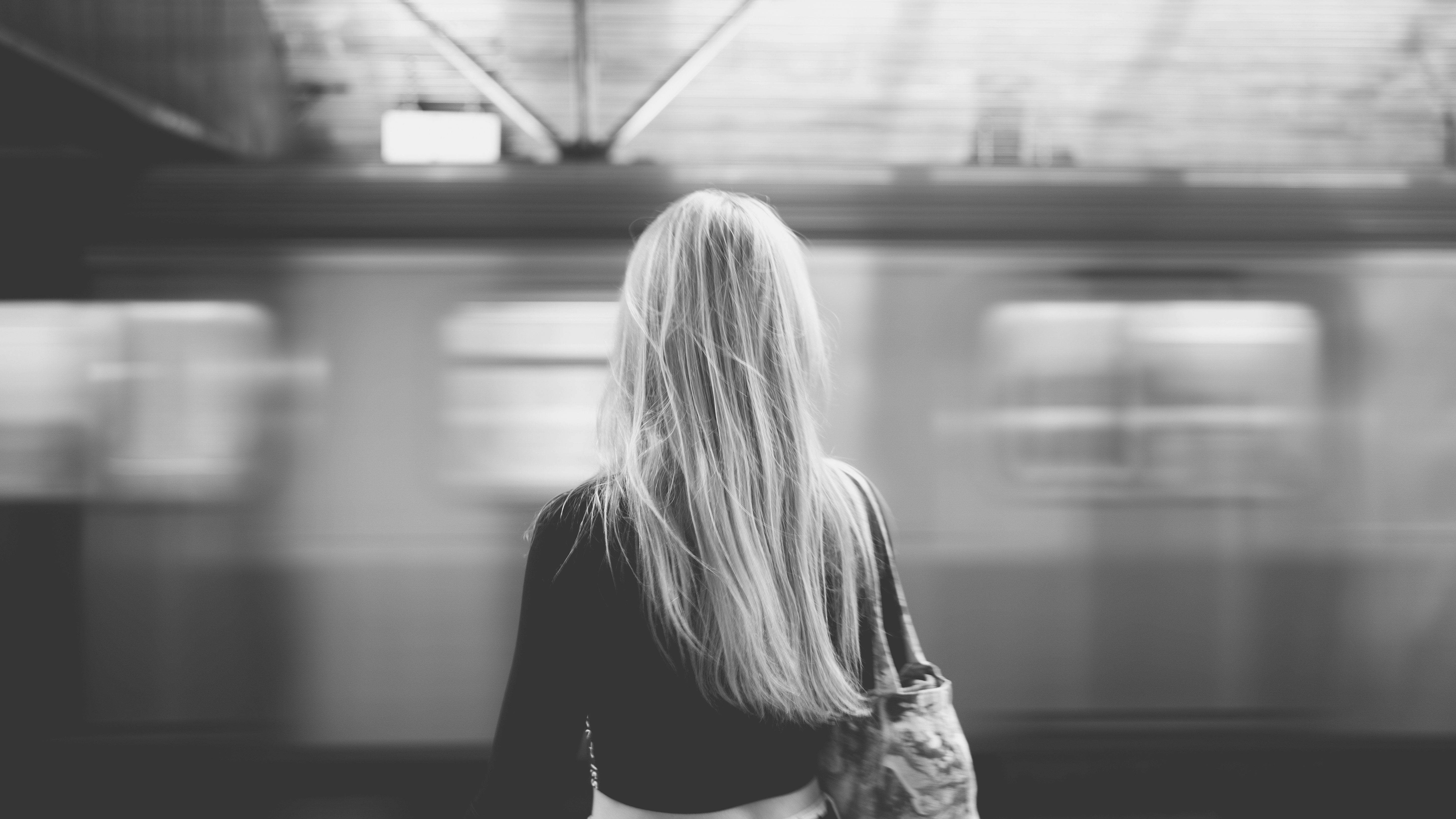 A woman standing in front of a train