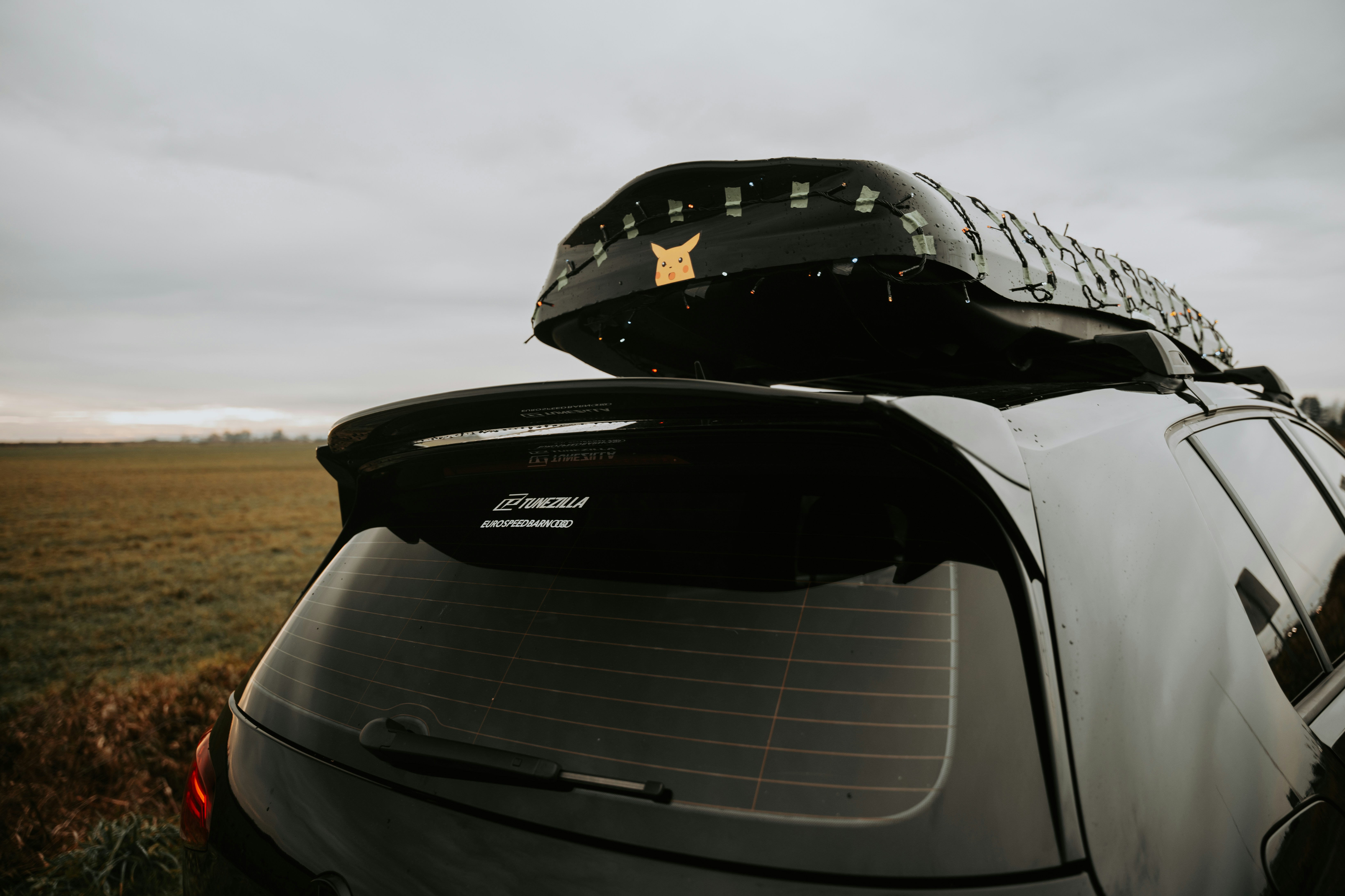 Row of used compact sedans lined up on a dealership lot