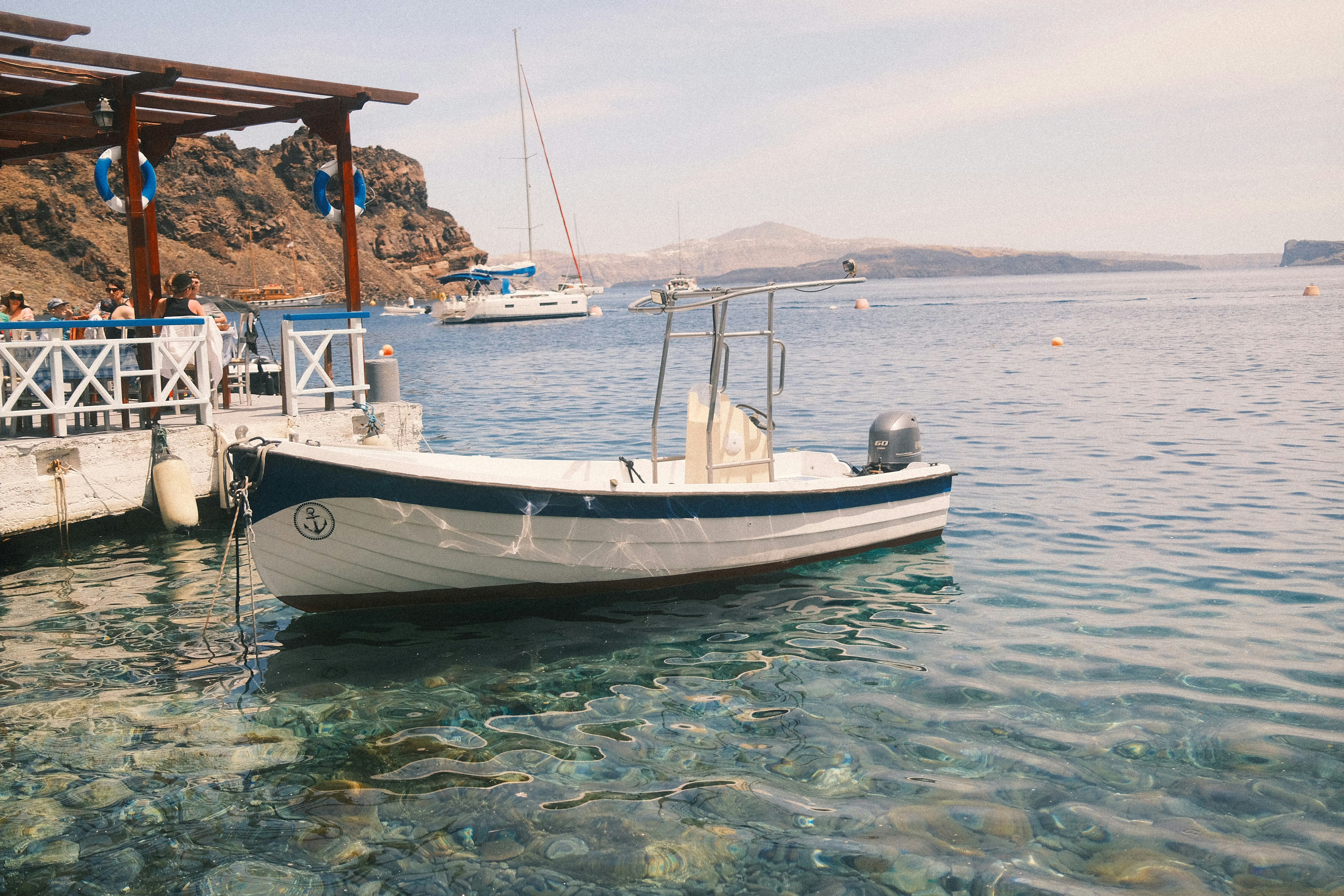 A small boat is docked at a pier